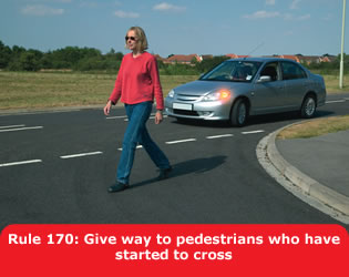 Give way to pedestrians who have started to cross